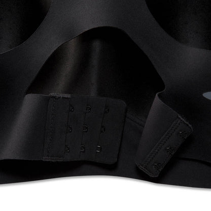 Close-up of a black seamless underwire bra showing the adjustable hook-and-eye back closure straps.
