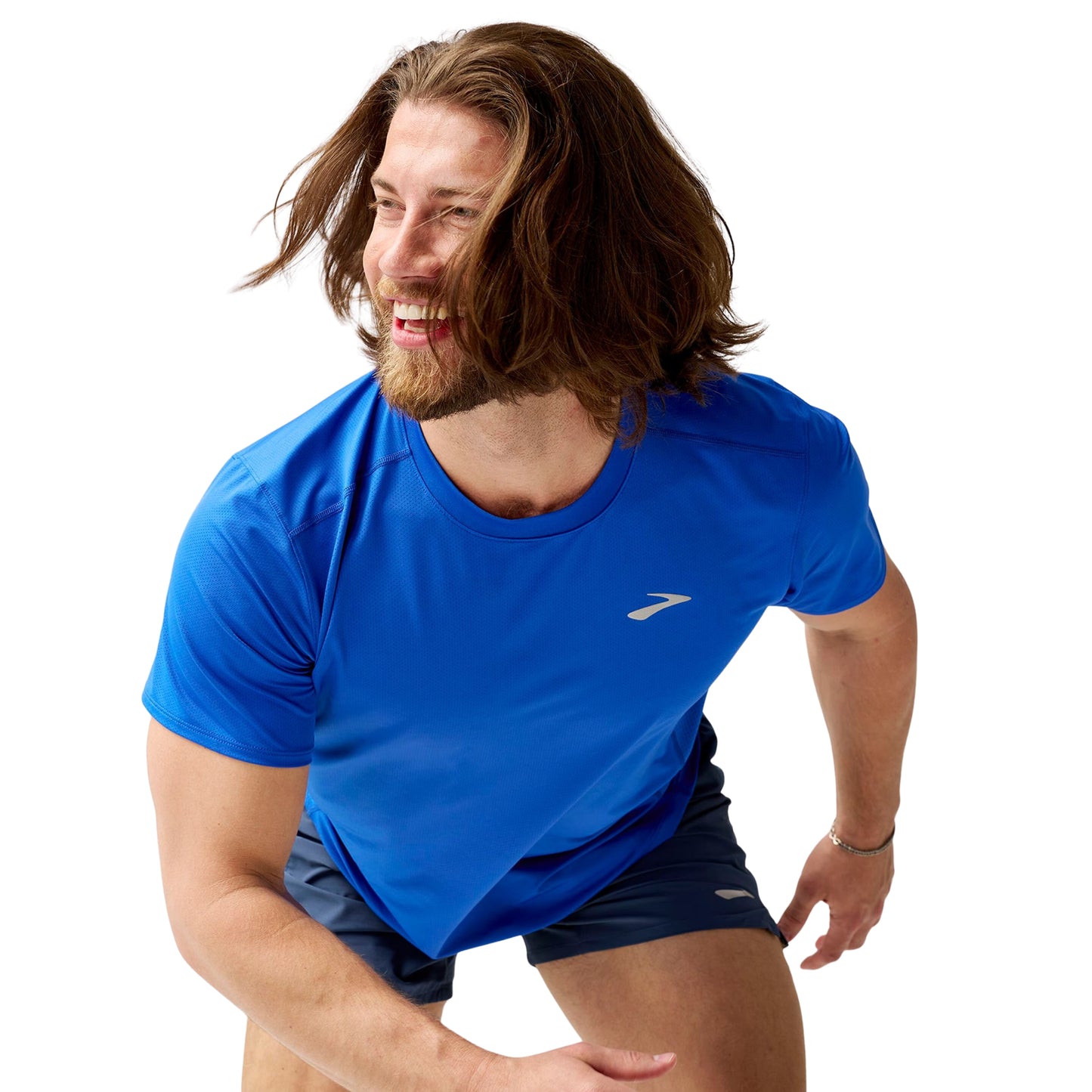 Man wearing a blue athletic shirt with a Brooks logo on a white background