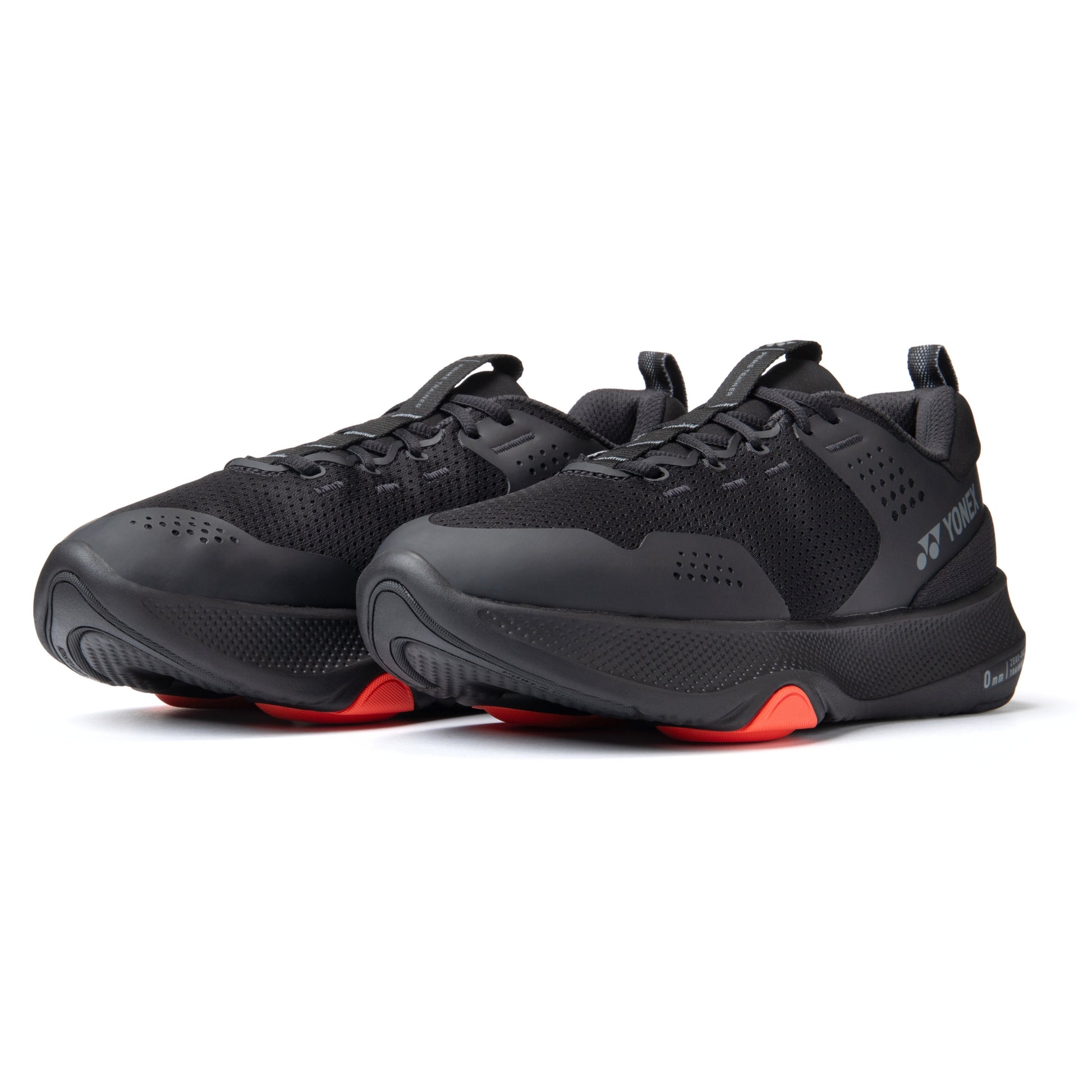 Black Yonex running shoes with red soles on a white background