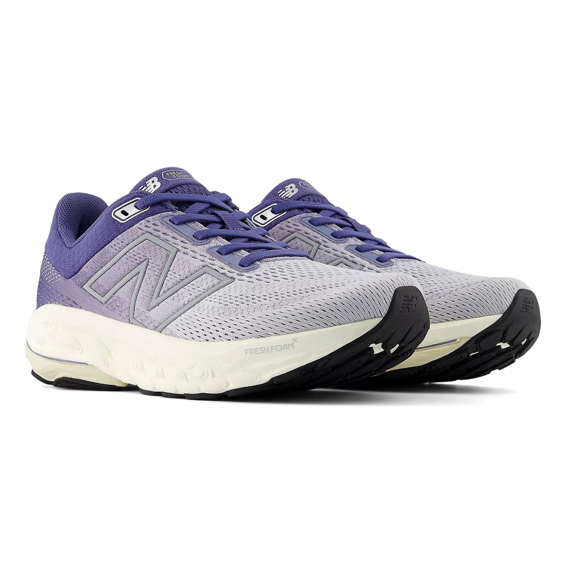 Pair of gray and purple running shoes on a white background