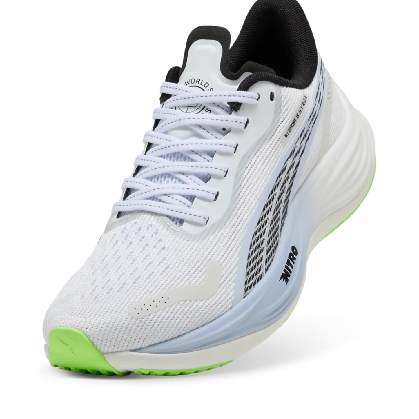 White Puma running shoe with green sole on a white background