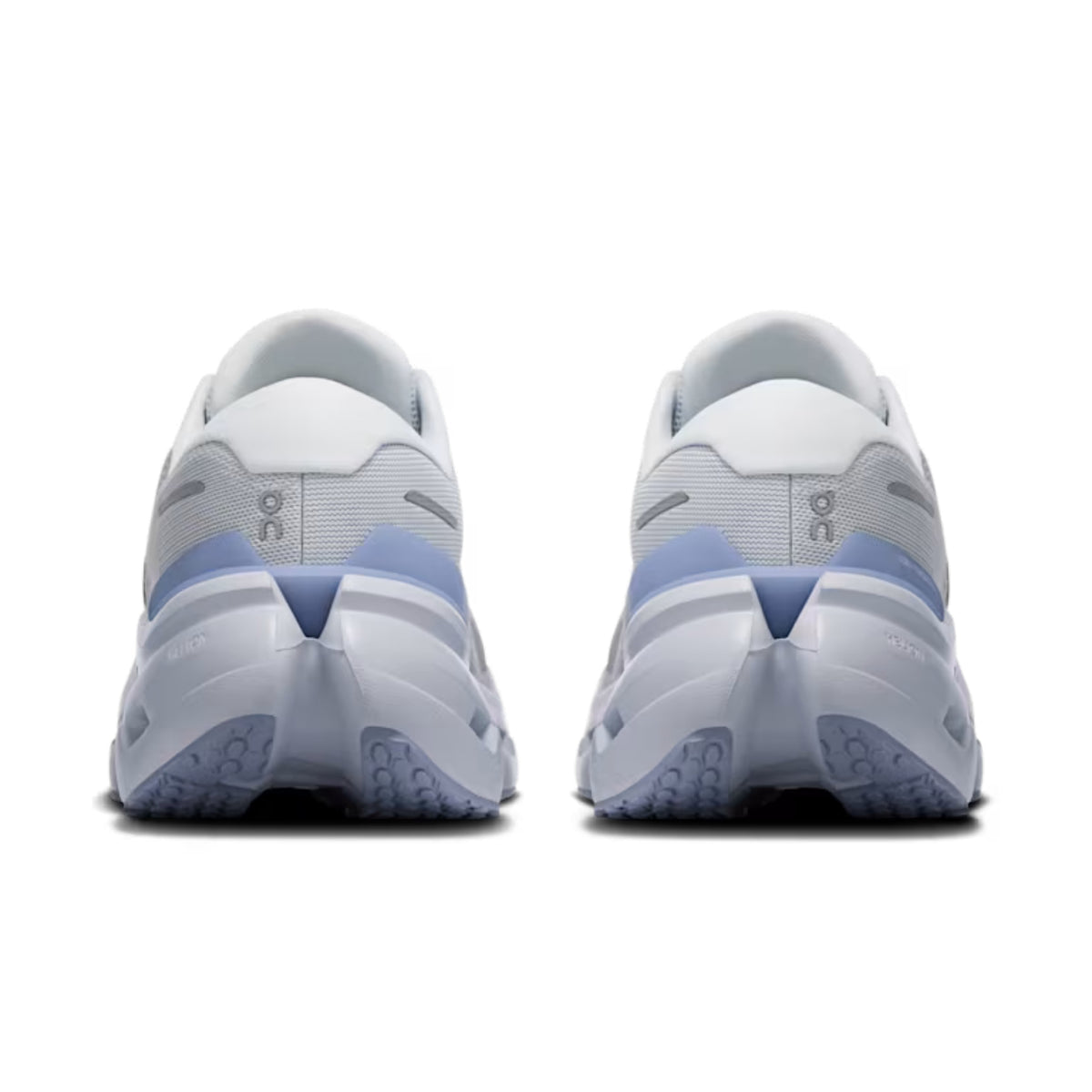 A pair of On running shoes shown from the back, featuring a white and light gray upper with light blue accents and a chunky white and blue sole.