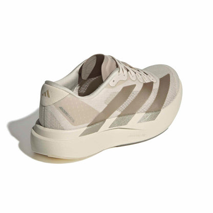 Beige running shoe with Adidas logo on a white background