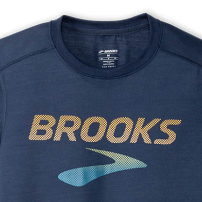 Navy blue athletic shirt with 'Brooks' logo on a white background