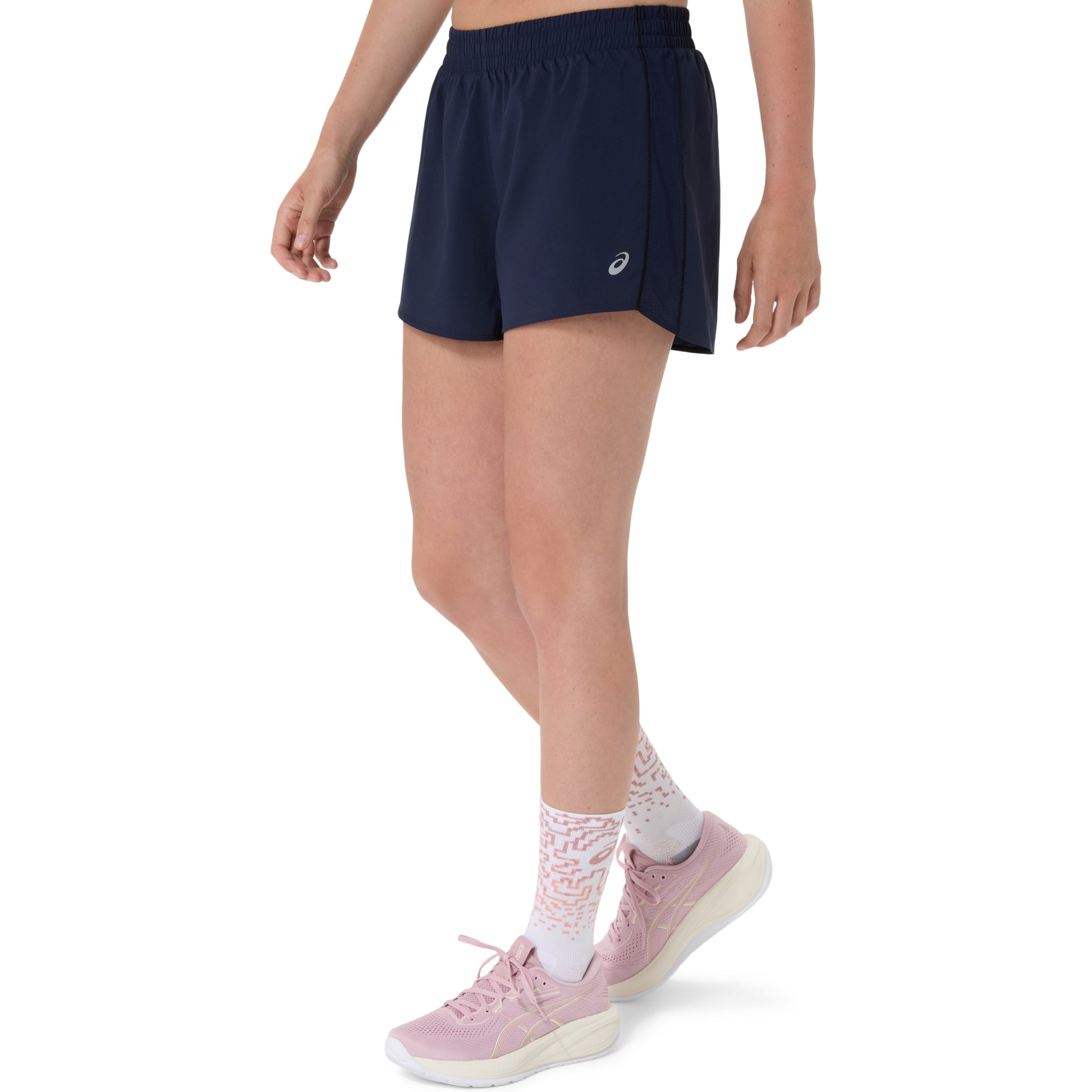 Person wearing navy Asics shorts with a brand logo on a white background