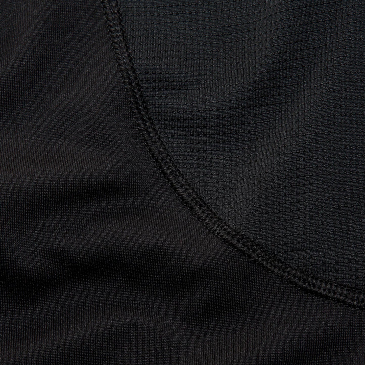 Close-up of a woman wearing a black long sleve shirt focusing on the details of the shirt
