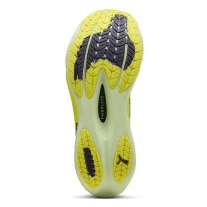 Yellow and black Puma running shoe sole on a white background