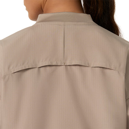 Close-up back view of a person wearing a light beige collared shirt with a buttoned chest seam and subtle vertical pinstripes.