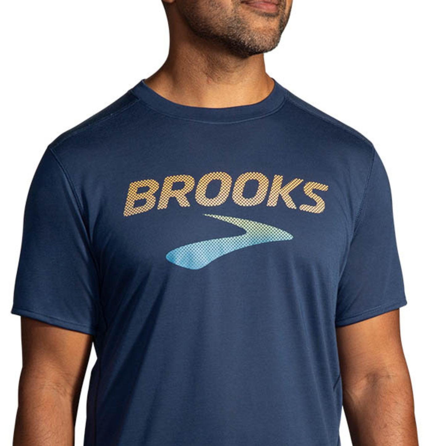 Man wearing a navy blue t-shirt with 'Brooks' logo on a white background