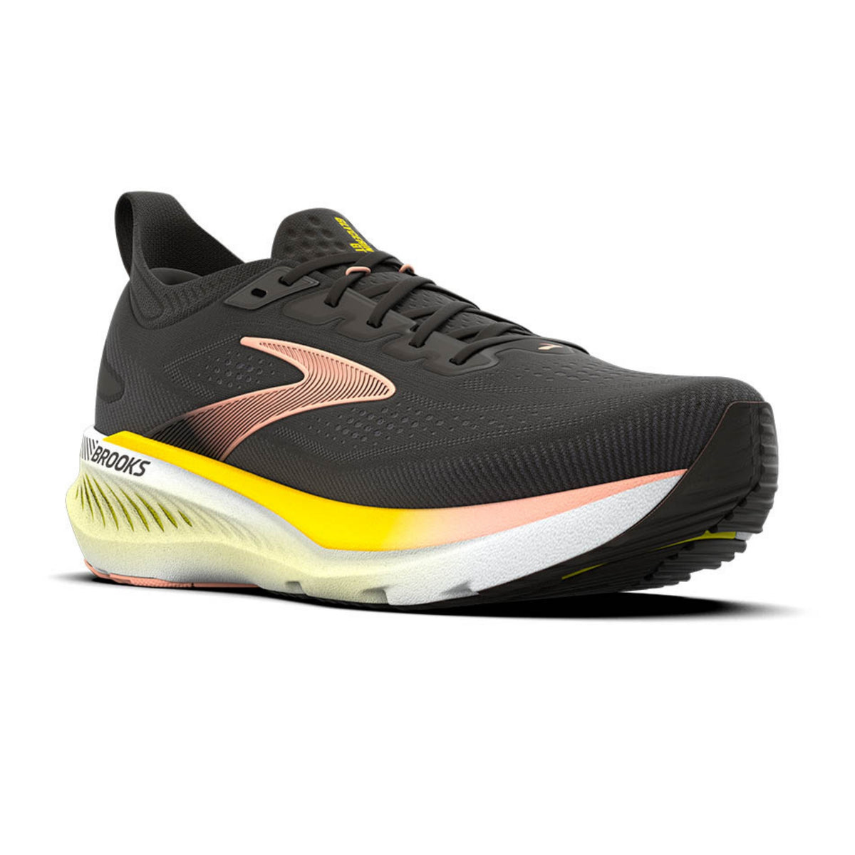 A Brooks running shoe in black with a metallic rose gold logo, a bright yellow midsole accent, and a white and yellow outsole, shown against a plain white background.