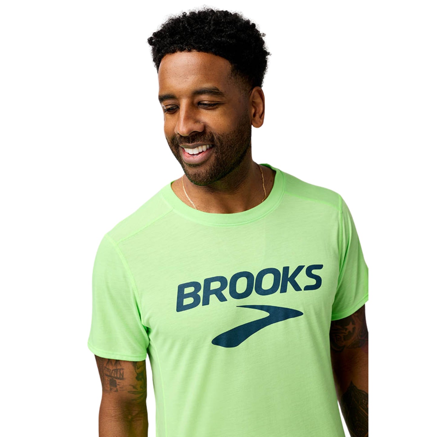 Man wearing a green 'Brooks' t-shirt on a white background
