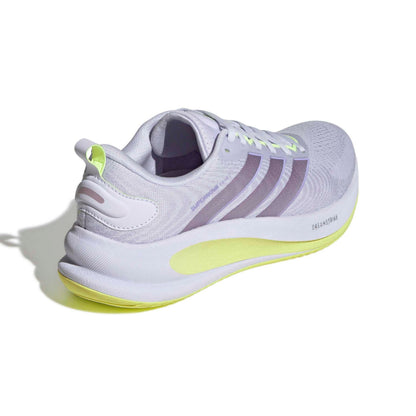 A white Adidas running shoe with light purple stripes, a white and purple collar, and a bright neon yellow sole and heel pull tab, shown from a three-quarters rear angle on a white background.