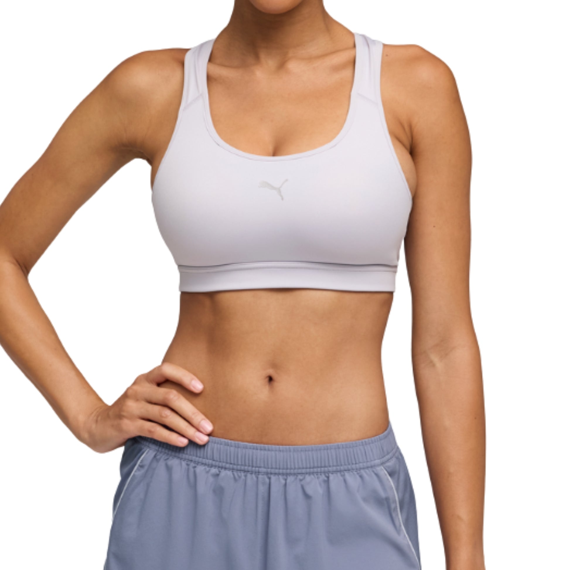Person wearing a white Puma sports bra and light blue shorts on a white background