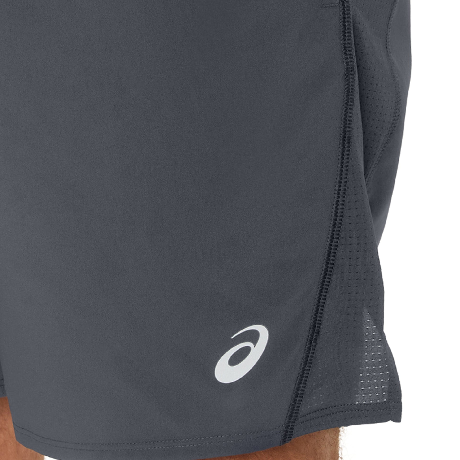 Close-up of dark gray running shorts with a brand logo on a white background