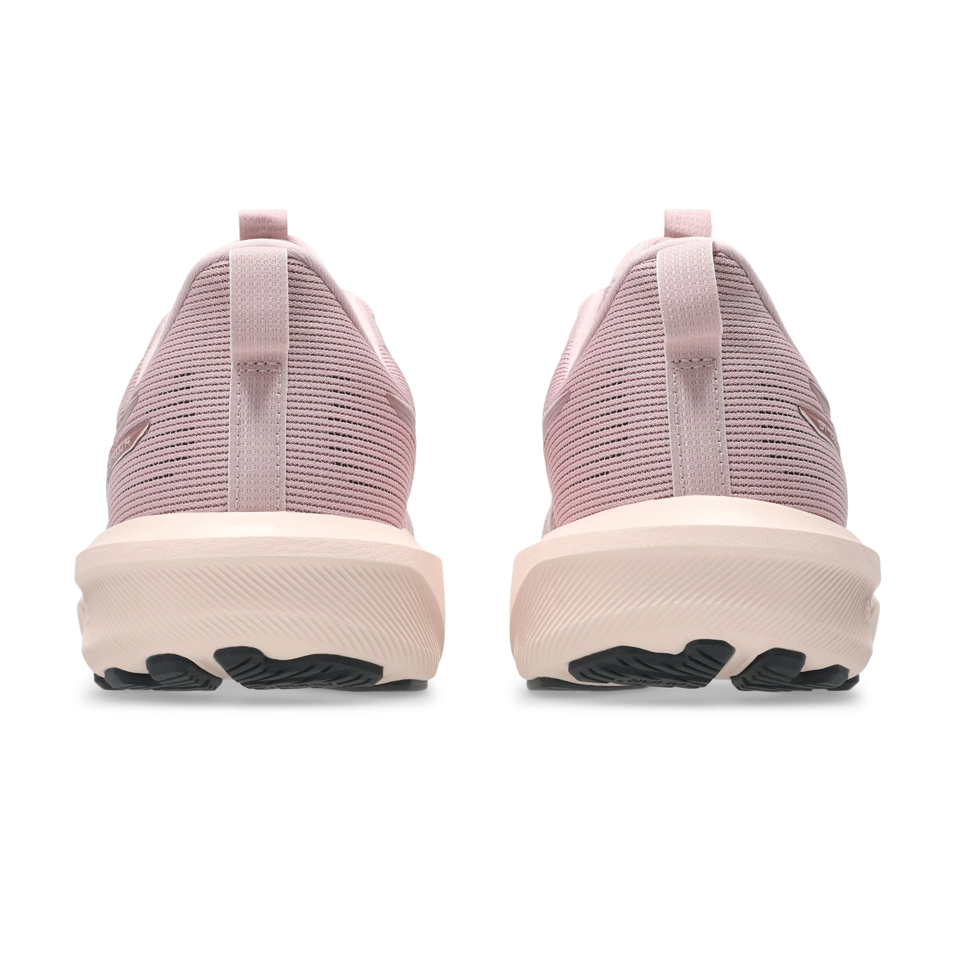 Pink running shoes with a white sole on a white background