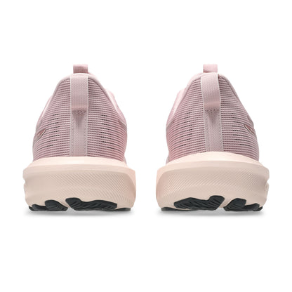 Pink running shoes with a white sole on a white background