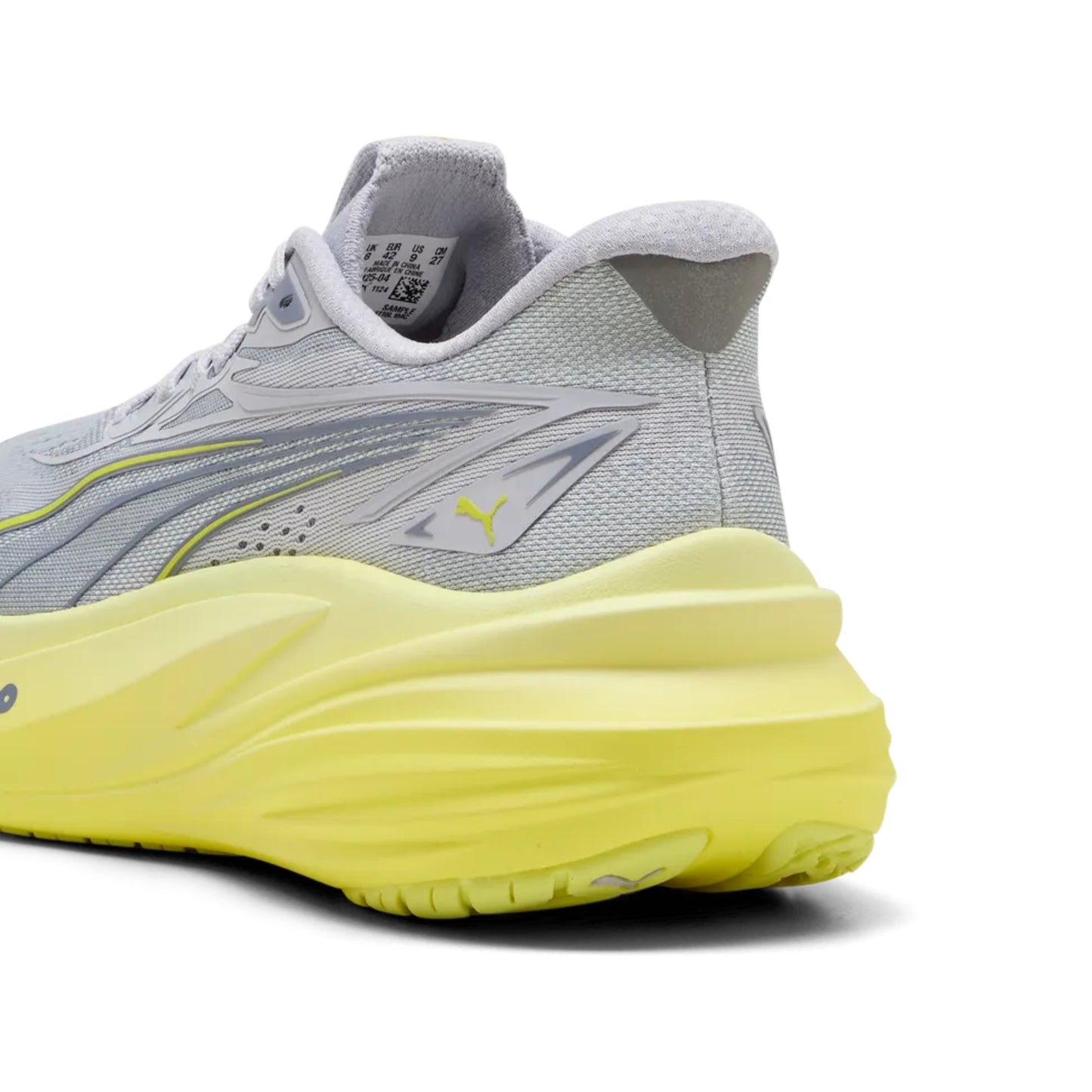 Gray Puma running shoe with yellow sole on a white background