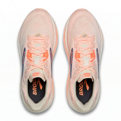 Pair of pink Brooks running shoes with orange accents on a white background