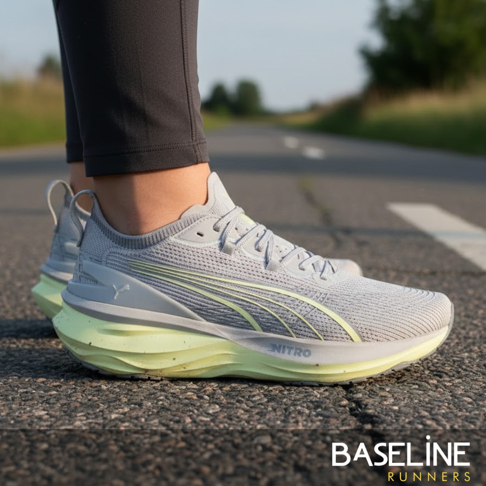 Gray and green Puma running shoes on a road with 'Baseline Runners' branding.