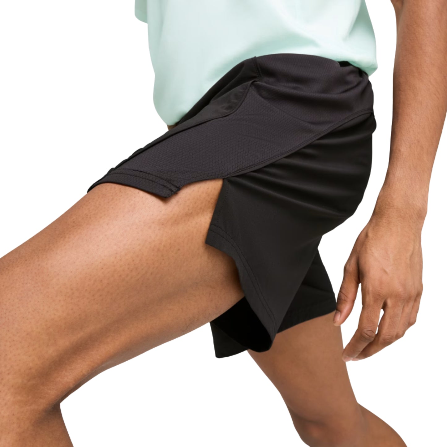 Person wearing a black Puma short on a white background