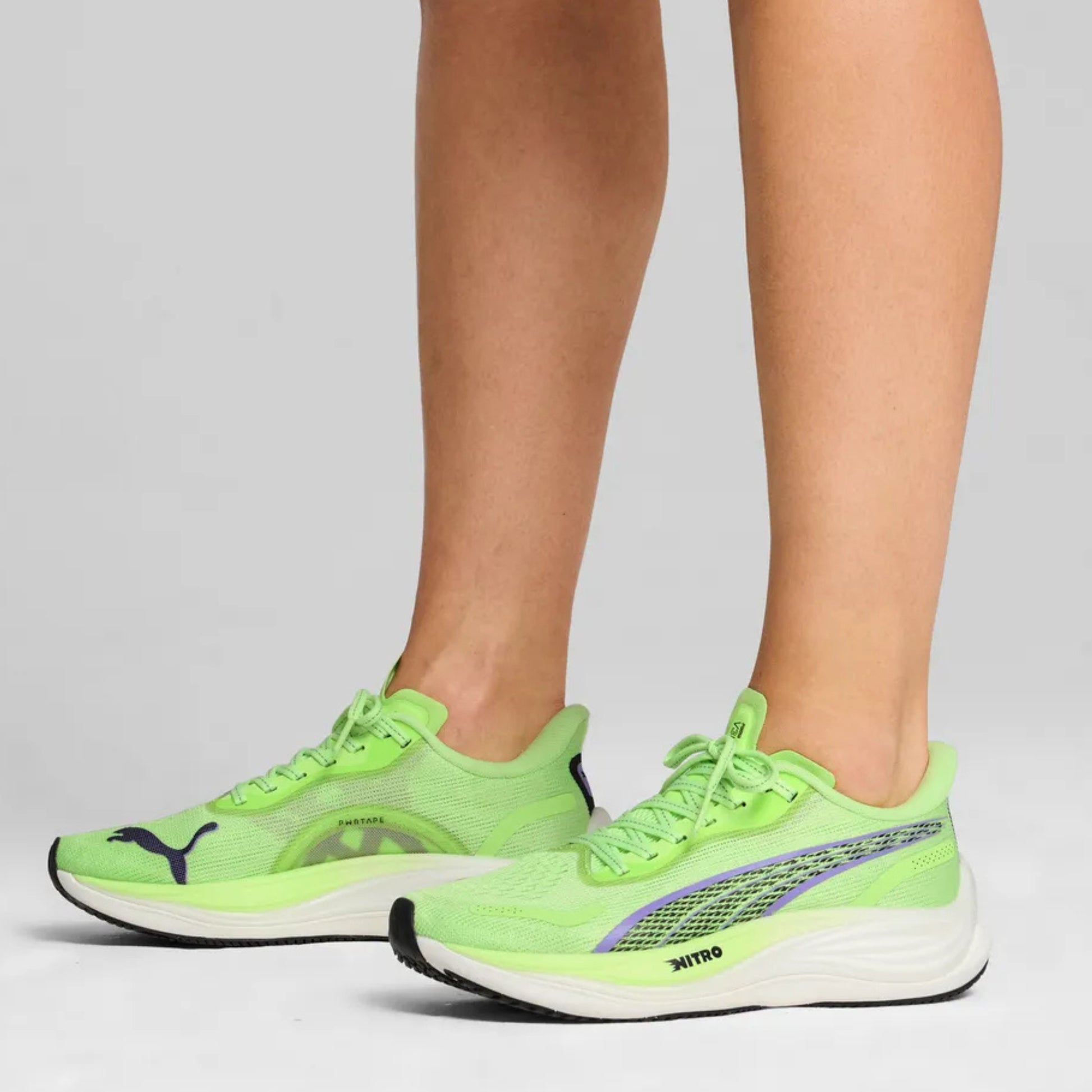 Green Puma running shoes with visible Puma logo on a neutral background