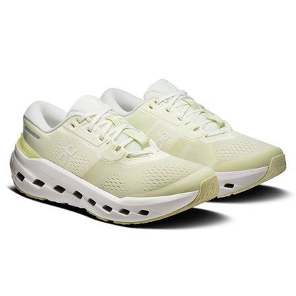 A pair of light yellow-green and white On running shoes with a chunky, cushioned sole, shown from a three-quarters angle on a white background.
