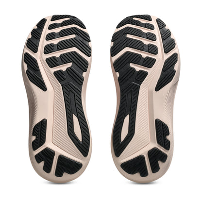 Close-up of the sole of a shoe with black tread pattern on a white background