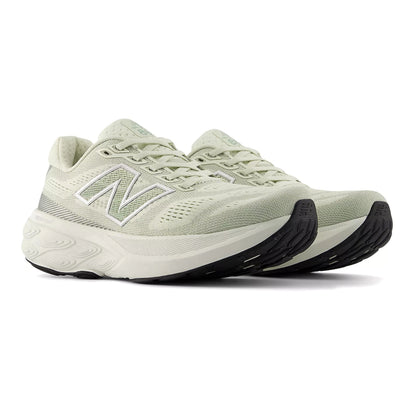 Light green running shoe with black sole on a white background