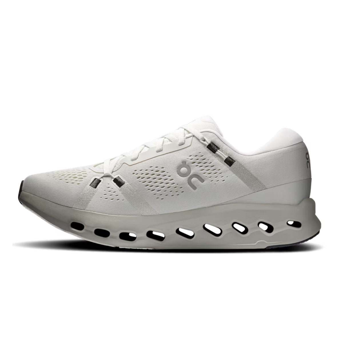 A white On running shoe with gray accents and a distinctive hollowed-out sole, shown in a side profile on a white background.