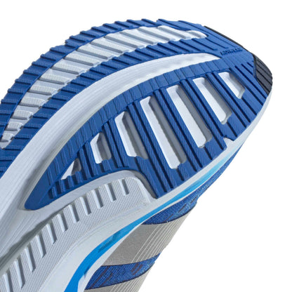 Close-up of a blue and gray adidas running shoe sole on a white background