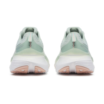 Pair of light green running shoes with white soles on a white background
