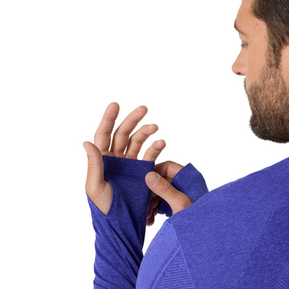 close-up og a man adjusting the Asics blue long sleeve shirt on a white background 