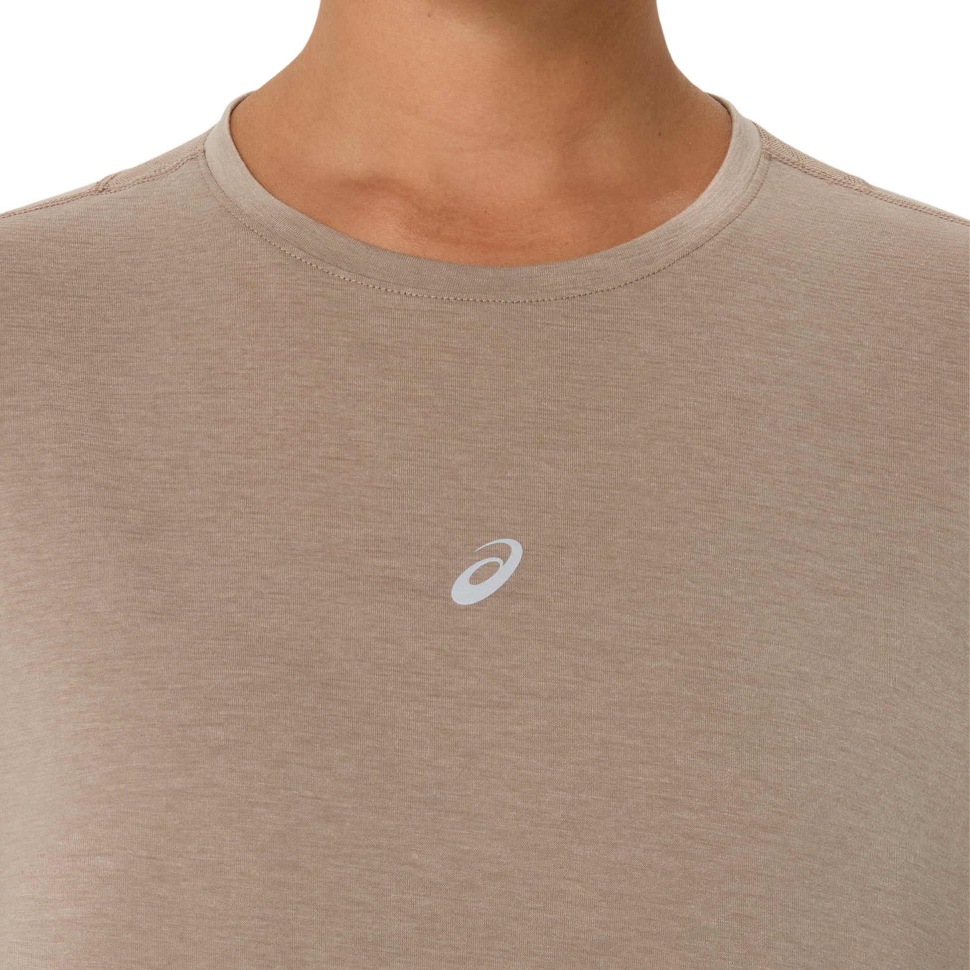 Close-up of a person wearing a heather taupe athletic t-shirt with a small white Asics logo on the chest, set against a plain white background.