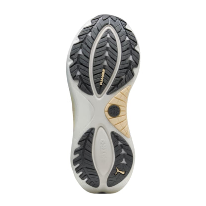 The outsole of a Puma running shoe, showing a white and gray treaded design with gold branding details, isolated on a white background.
