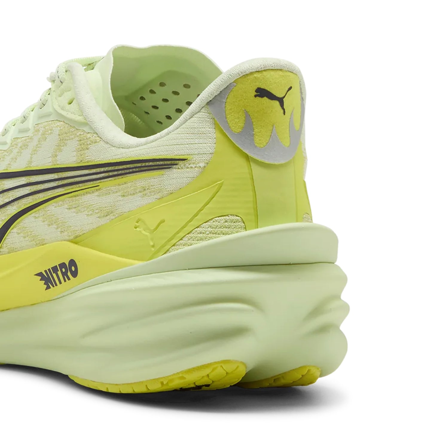 Yellow Puma running shoe with Puma logo on a white background