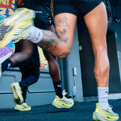 People running with Puma shoes on a road