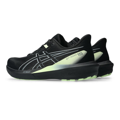 Black Asics running shoes with yellow accents on a white background