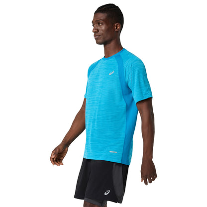 Man wearing a blue Asics shirt with a visible brand logo on a white background