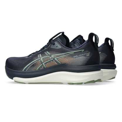 Navy blue Asics running shoes with green and gold accents on a white background