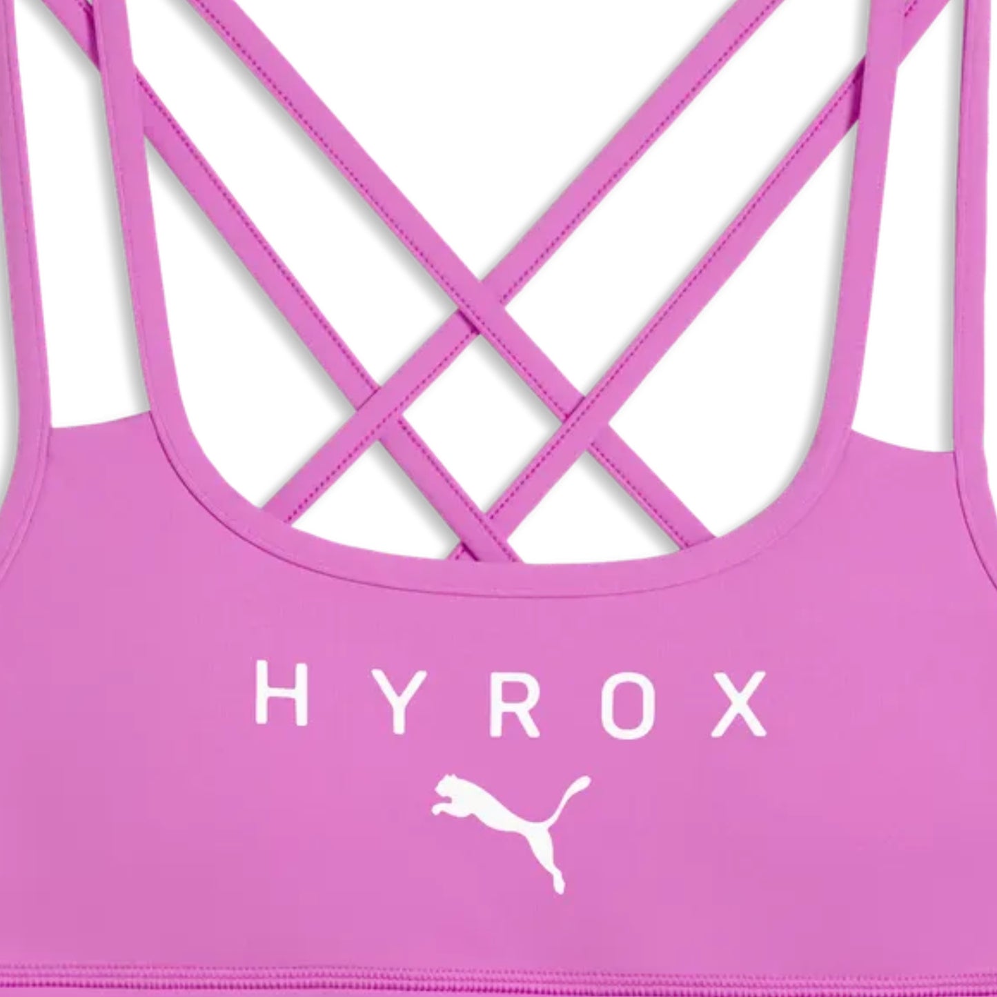 Pink sports bra with criss-cross straps and 'HYROX' branding on a white background