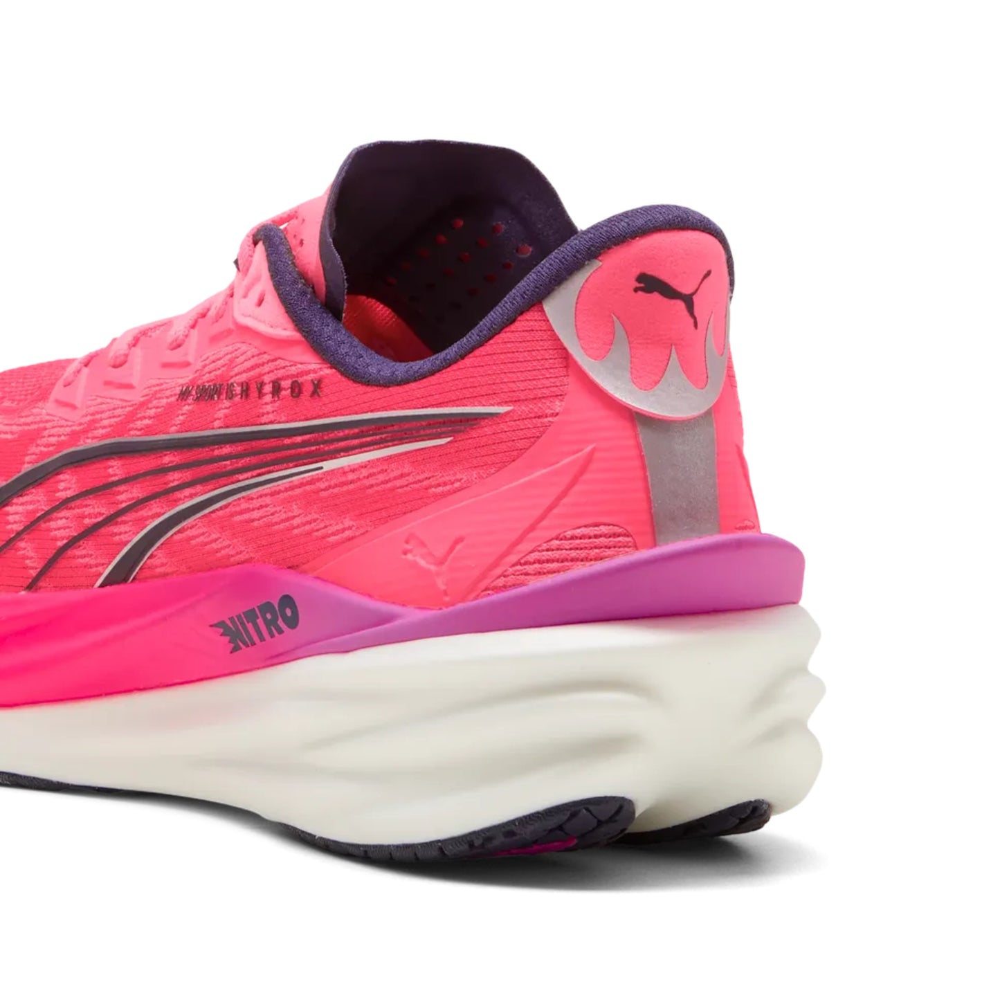 Pink Puma running shoe with white sole on a white background