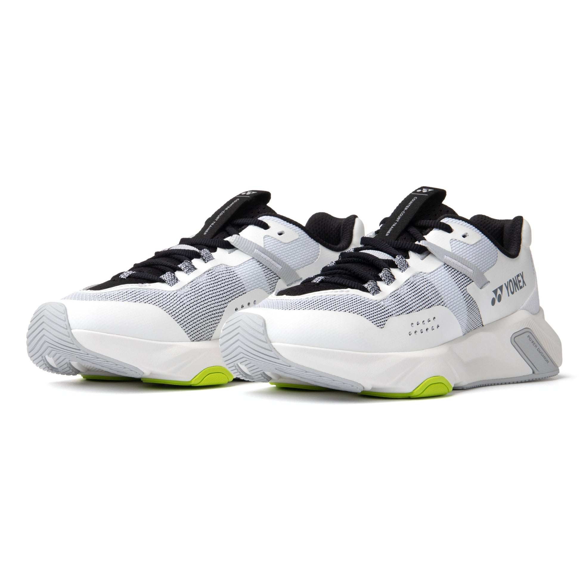 White and black Yonex running shoes with green accents on a white background