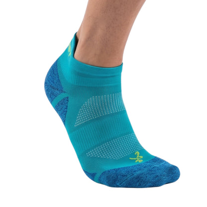 A single ankle-length athletic sock worn on a model's foot, shown against a plain white background. The sock is primarily turquoise with darker blue textured panels on the heel, toe, and sole, and a small yellow logo near the toe.