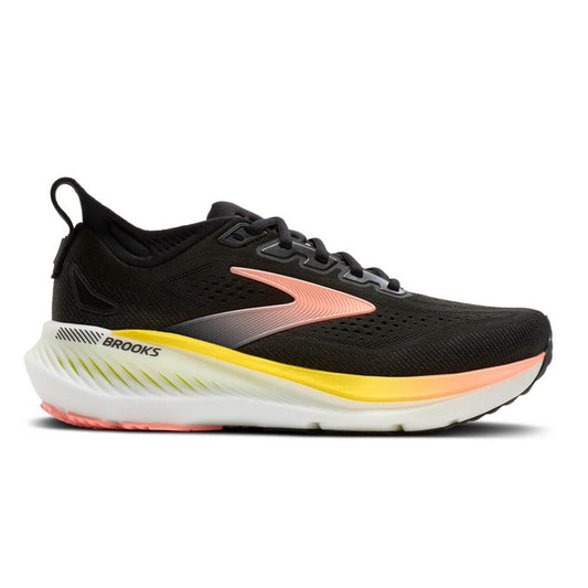 Brooks running shoe in black with a coral-pink and yellow midsole accent, shown from the side on a white background.