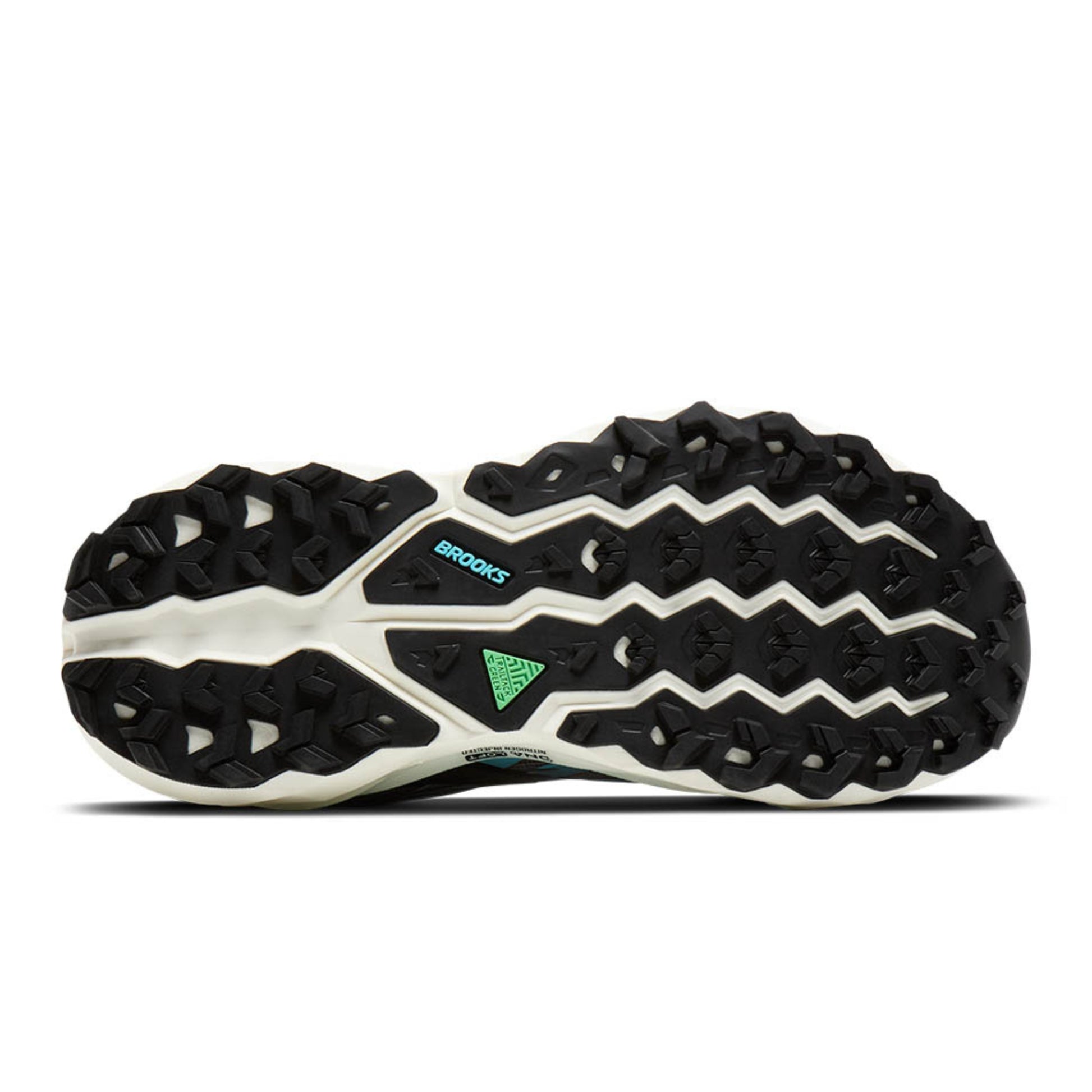 Sole with black and white Brooks running shoe with green accents on a white background