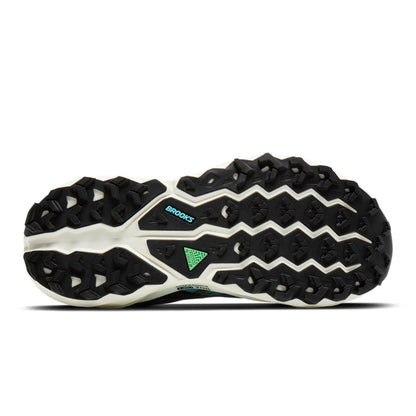 Sole with black and white Brooks running shoe with green accents on a white background