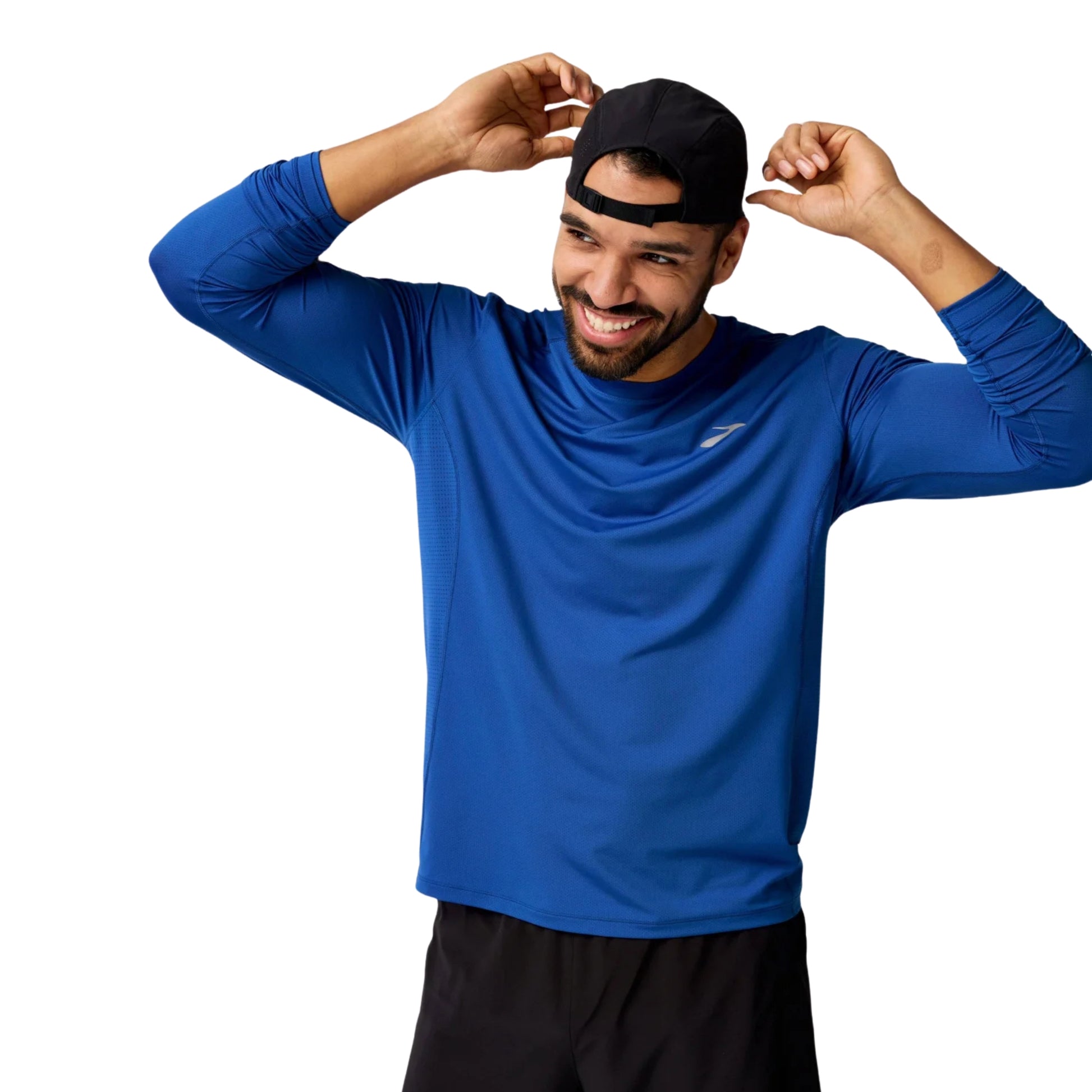 Man wearing a blue Brooks long sleeve shirt on a white background