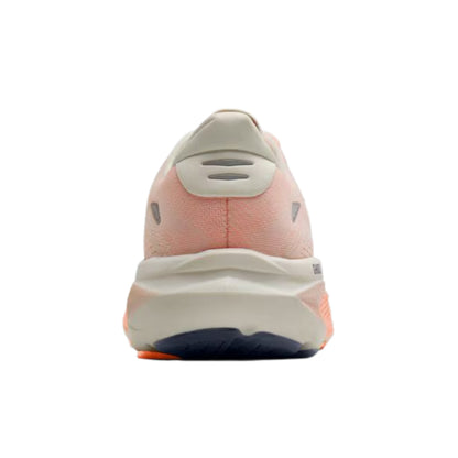 A rear view of a Brooks running shoe on a solid white background, featuring a peach-pink upper, a thick cream midsole, and a dark navy outsole.