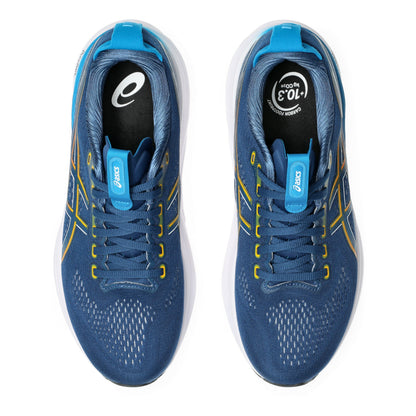 Blue running shoes with yellow accents on a white background
