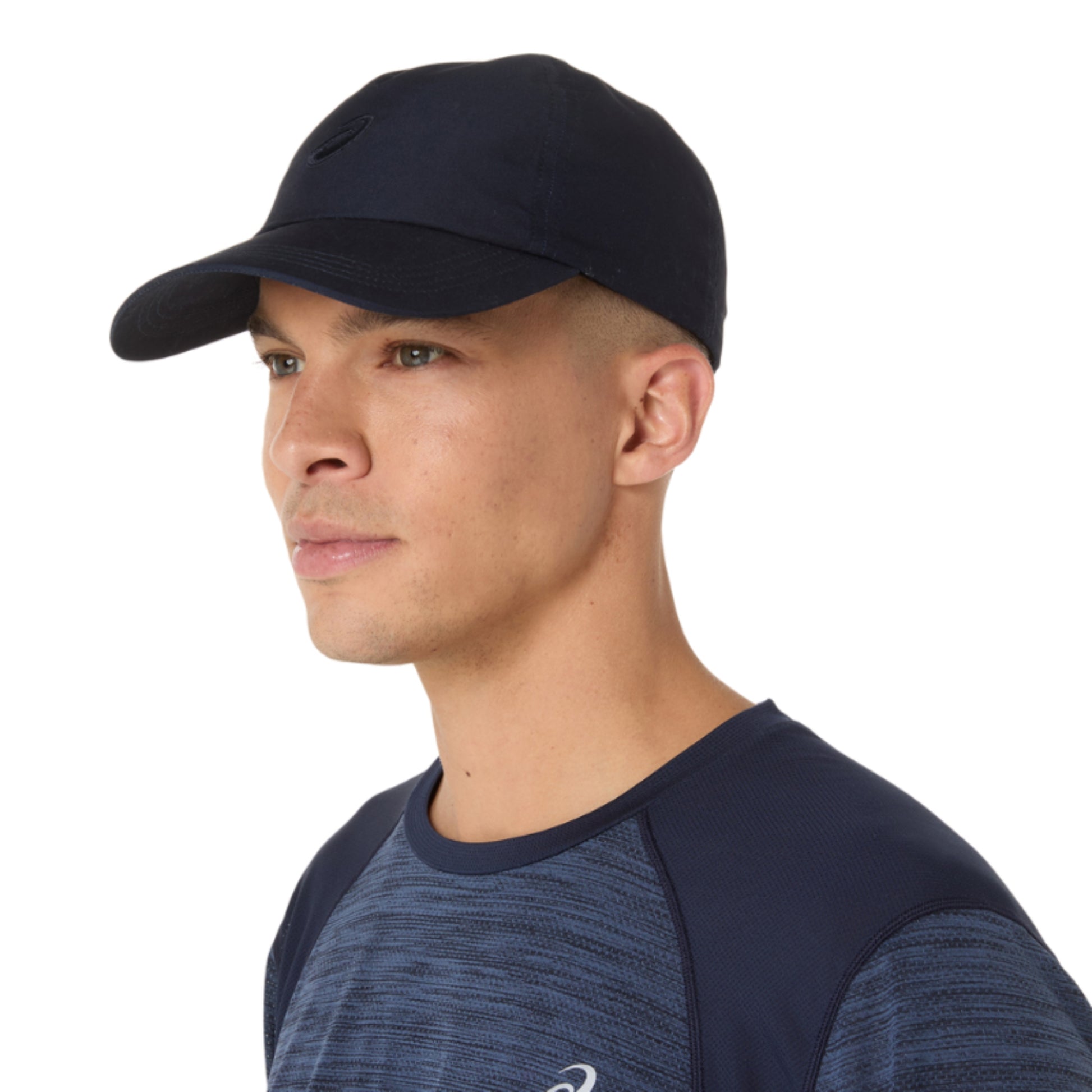 Man wearing a navy cap and athletic shirt on a white background